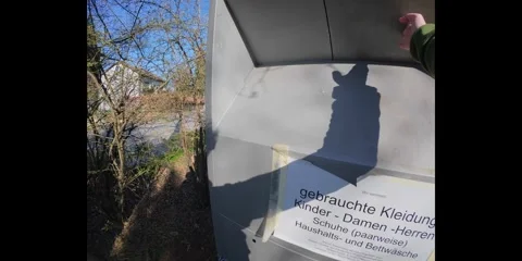 Donating used items to a charity container in Germany. First-person perspective Video stock 316682856