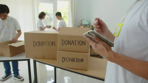 Donation Center Volunteer Using Tablet Computer 動画素材 275010331