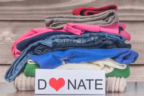 Donation concept. Donation box with donation clothes on a  Charity. Helping p Stock Photos