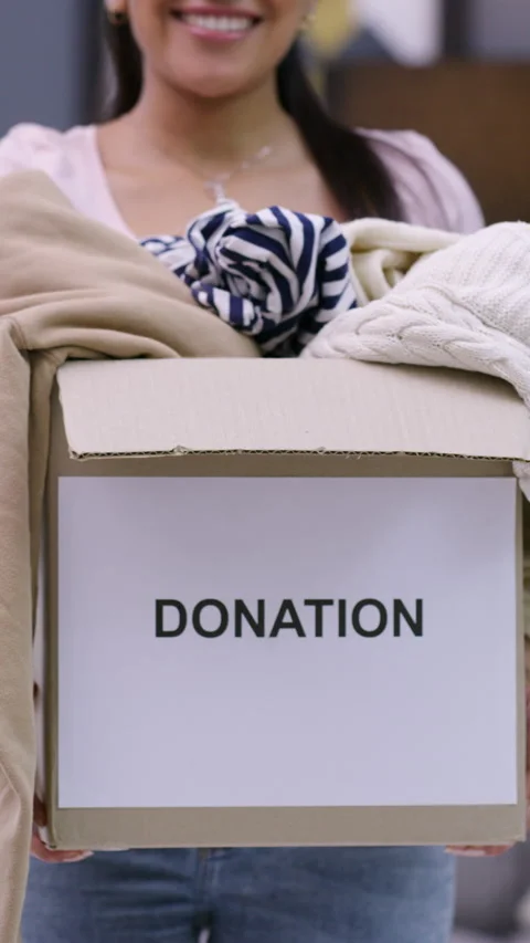 Donation, hands or box of clothes in home, sustainability practice or generosity Stock Footage 324015104