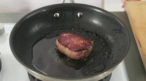 Doneness of steak being tested with a thumb Stock Footage 24648330