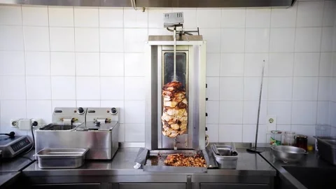 Donner kebab chicken meat or shawarma on a rotating vertical spit. Fat drips Stock Footage 277410273