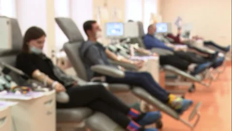 Donor donate blood while sitting in chairs. Noise, blurred. Vídeo Stock 148148612