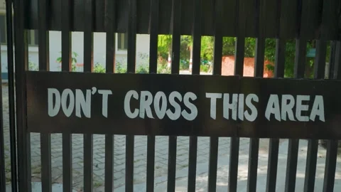 Don't cross this area warning sign on black gate Stock Footage 333380117