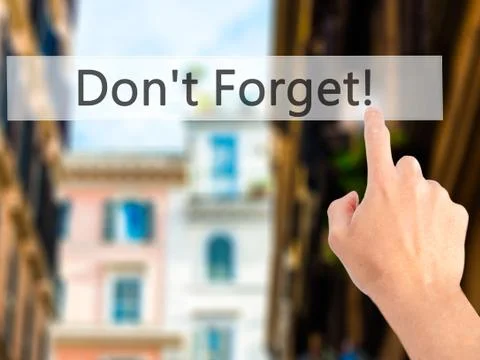 Don't Forget! - Hand pressing a button on blurred background concept on visua Stock Photos