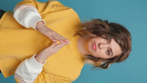 Don't know gesture hesitant young woman stands with her arms crossed Stock Footage 153839028