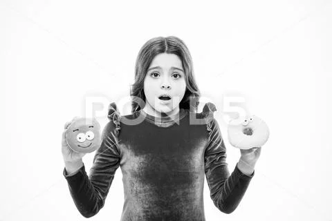 Dont know which to eat first. Small kid in doughnut bakery. Little child with Stock Photos