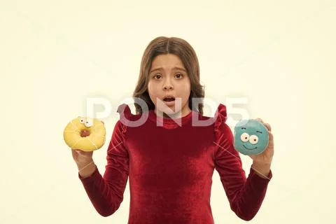 Dont know which to eat first. Small kid in doughnut bakery. Little child with Stock Photos