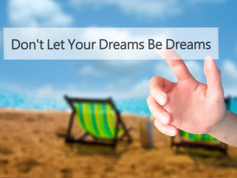 Don't Let Your Dreams Be Dreams - Hand pressing a button on blurred backgroun Stock Photos
