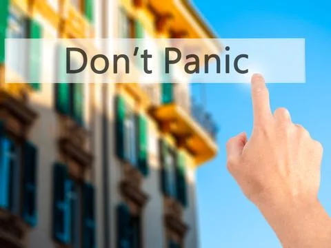 Don't Panic - Hand pressing a button on blurred background concept on visual  Stock Photos