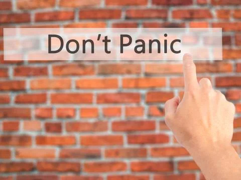 Don't Panic - Hand pressing a button on blurred background concept on visual  Foto stock
