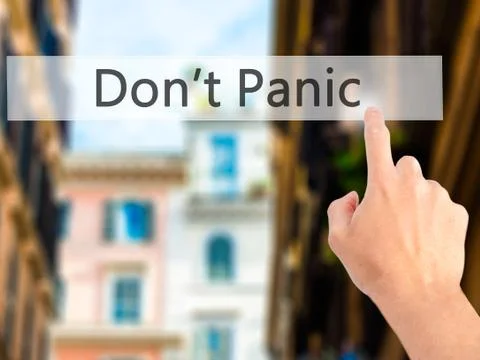 Don't Panic - Hand pressing a button on blurred background concept on visual  Foto stock