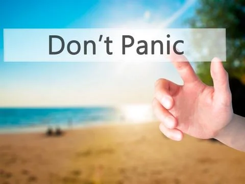 Don't Panic - Hand pressing a button on blurred background concept on visual  Foto stock
