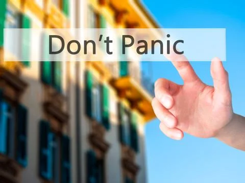 Don't Panic - Hand pressing a button on blurred background concept on visual  Stock Photos
