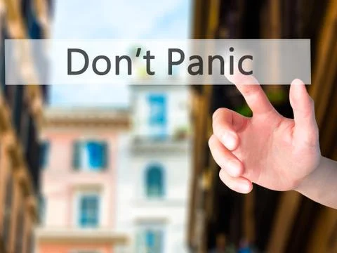 Don't Panic - Hand pressing a button on blurred background concept on visual  Foto stock