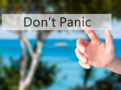Don't Panic - Hand pressing a button on blurred background concept on visual  Foto stock