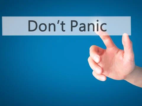 Don't Panic - Hand pressing a button on blurred background concept on visual  Stock Photos