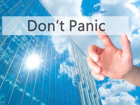 Don't Panic - Hand pressing a button on blurred background concept on visual  Stock Photos
