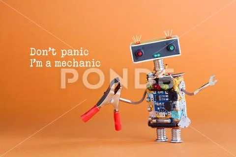 Don't panic I'm a mechanic concept. Toy robot handyman with pliers ready for Stock Photos