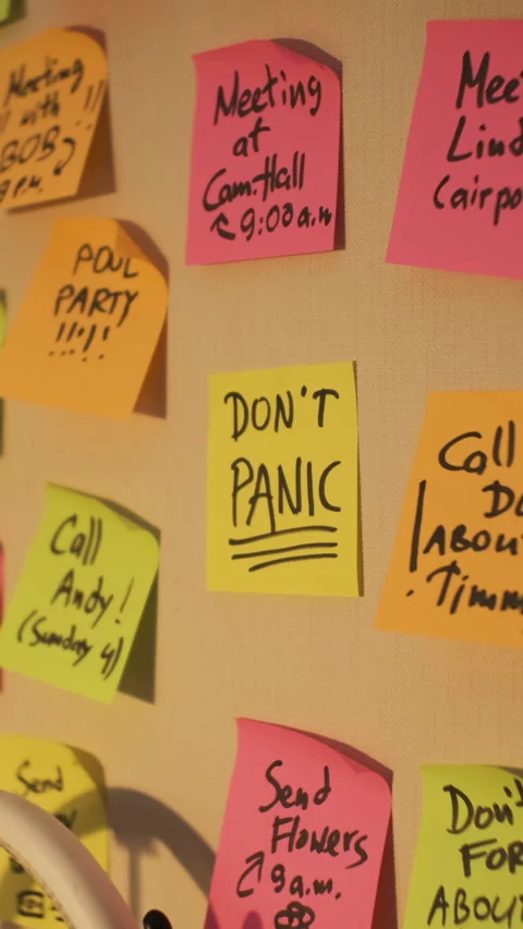 Don't panic note stuck on office wall Stock Footage 284031726
