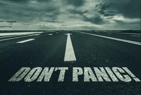 Dont Panic written on the road. Stock Photos