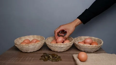 Don't put all your eggs in one basket concept. eggs in a rattan basket Stock Footage 233517867