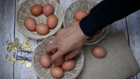 Don't put all your eggs in one basket concept. eggs in a rattan basket Stock Footage 233518508