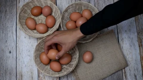 Don't put all your eggs in one basket concept. eggs in a rattan basket Stock Footage 233518624