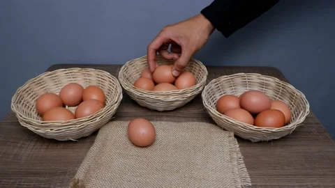 Don't put all your eggs in one basket concept. eggs in a rattan basket Stock Footage 233518756