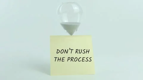 Don't Rush The Process written on yellow sticky note placed on hourglass Stock Footage 313475948