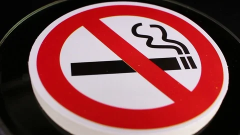 Don't smoking do not smoke sign closeup texture video on rolling rotating Stock Footage 104335592