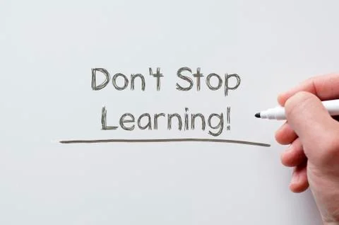 Don't stop learning written on whiteboard Stock Photos