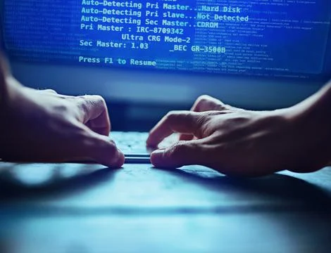 Dont trust anyone with your data. an unidentifiable hacker using a computer late Stock Photos