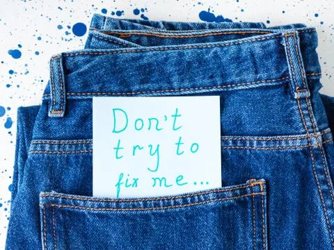 Don't try to fix me message in jeans pocket Stock Photos