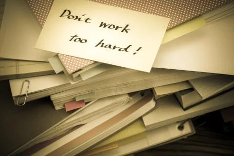 Don't Work Too Hard; The Pile of Business Documents on the Desk Foto stock