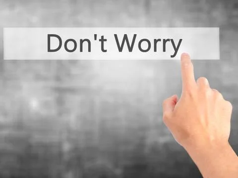 Don't Worry - Hand pressing a button on blurred background concept on visual  Stock Photos