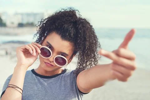Dont you dare throw shade. a young woman showing middle finger. Stock Photos