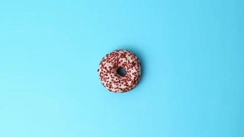 Donut on a blue background. top view. Video stock 243500246