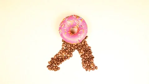 Donut with coffee beans on a white background. Gait stop motion animation. Stock Footage 136468463