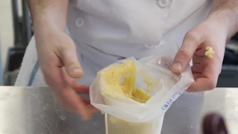 Donut dough being put into a plastic container Stock-Footage 307339957