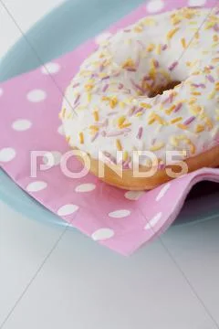 Donut with icing and sprinkles Stock Photos
