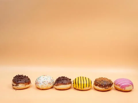 Donut on an orange background. Stock Photos