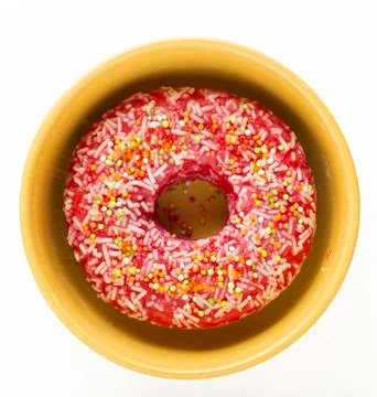 Donut pink with multi-colored pastry crumbs unhealthy dessert. Stock Photos