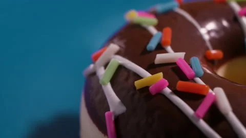 Donut rolling, close-up on a blue background 4k Stock Footage 131118098