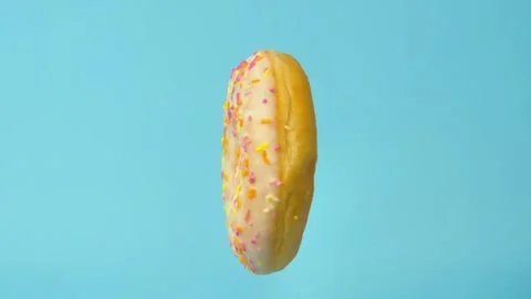 Donut rotates on a blue background Video stock 243674664