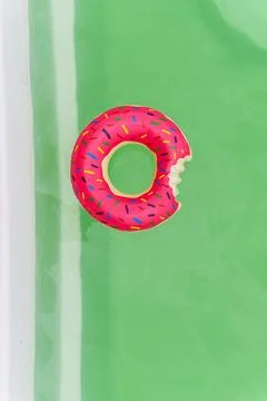 Donut-shaped inflatable circle on the surface of the pool. Stock Photos