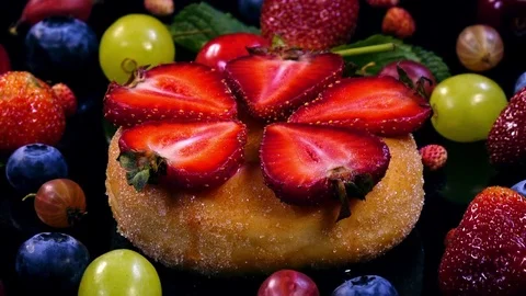 Donut with sliced strawberry and mixed berries and fruits 4K 動画素材 78506053