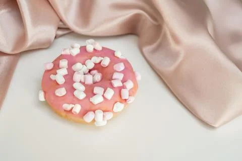 Donut with splashes, on a white background, with a silk cloth, delicate Stock Photos