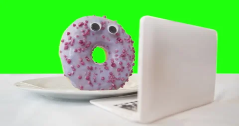 Donut using laptop. Watching content about the harmful of sugar. Green screen 스톡 동영상 237118638