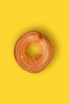 Donut on yellow background. Top view. Copy space. Stock Photos